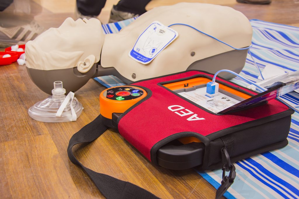 A defibrillator being used during first aid & CPR training